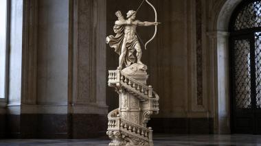 Statues of men A figurine of Cupid with a bow on an architectural column with a spiral staircase 3d model